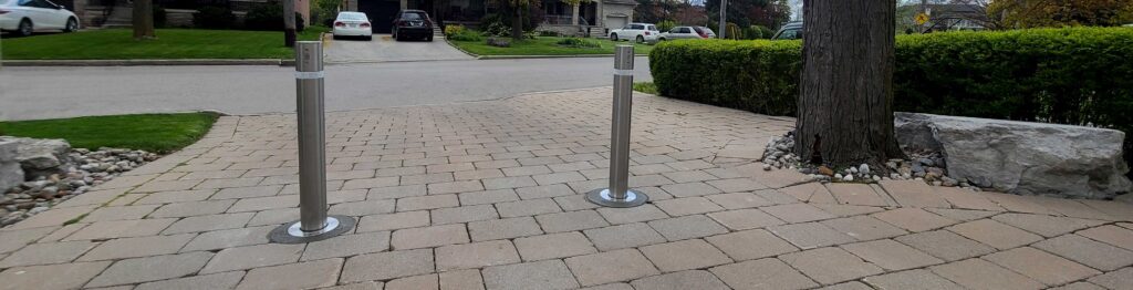 residential automatic retractable bollards in a driveway