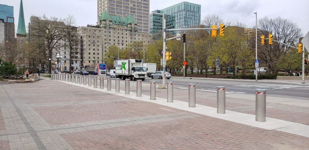 row of annt bollards lining the street in front of city hall